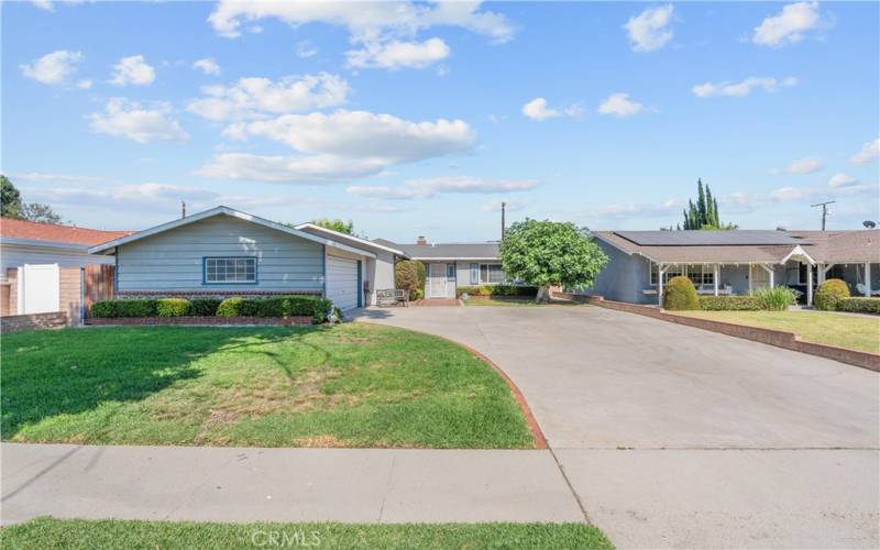 Handsome curb appeal with a large concrete driveway, attached two car garage, and a composition roof.