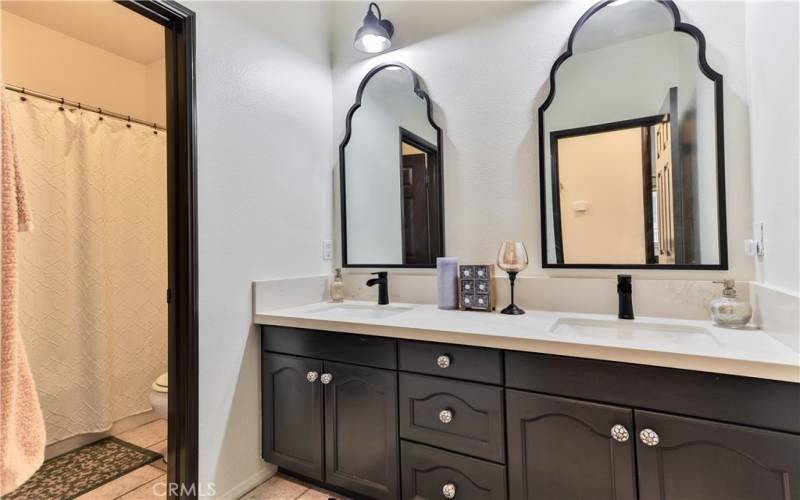 Hall bath upstairs double sinks, new counter top and faucets. custom mirrors