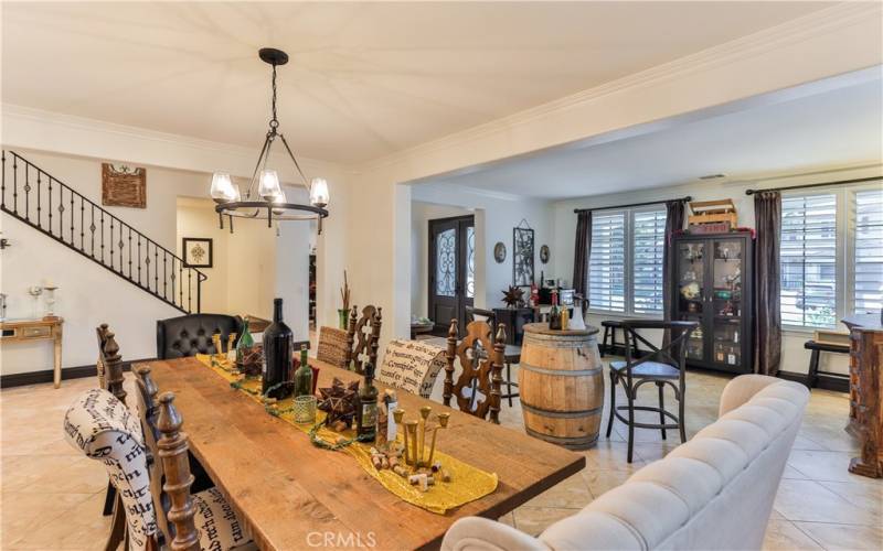 View of living area and large dining area, tinted windows.