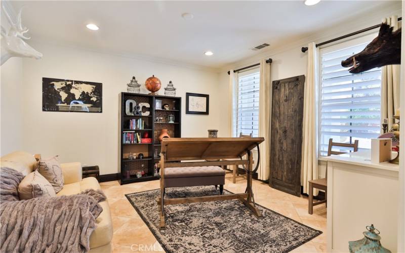 Downstairs room to the right , crown molding, tinted windows, baseboards