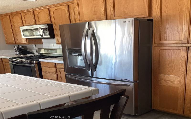 To the right of the refrigerator is a nice size large pantry. This is a breakfast bar.