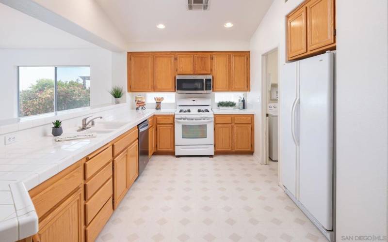 Spacious kitchen has ample cupboards and storage.  The kitchen is open to the Living Room.