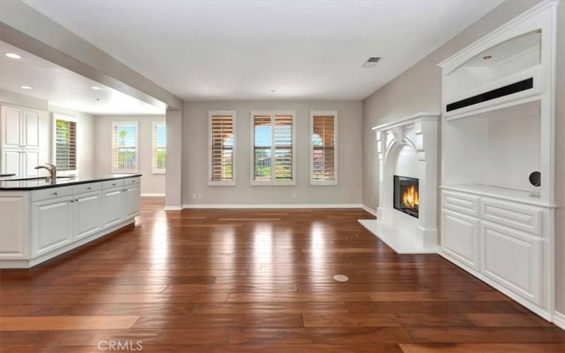 Looking at living room adjacent the open kitchen with breakfast nook.