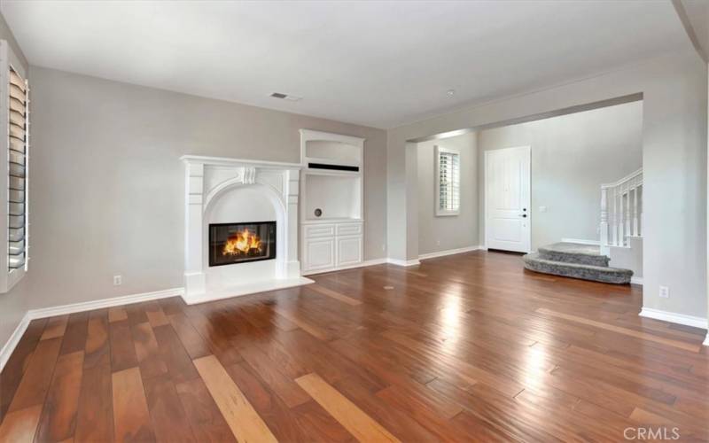 Living room with fireplace and built-in cabinet for tv.