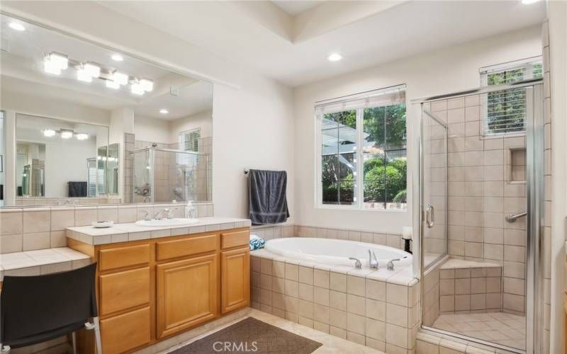 Large bathroom with big-size tub, Walk-in shower, and double sinks.