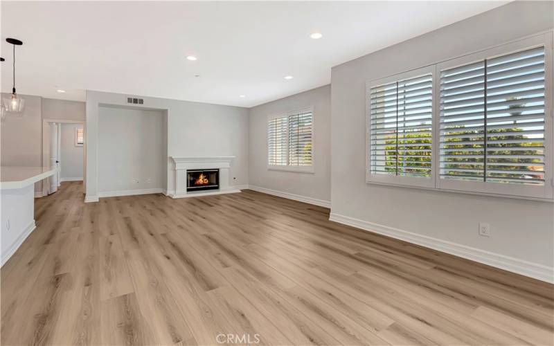 Living space with fireplace, media niche, dining area and bar counter.  New LED lighting throughout, plantation shutters, closet organizers, new fixtures throughout.