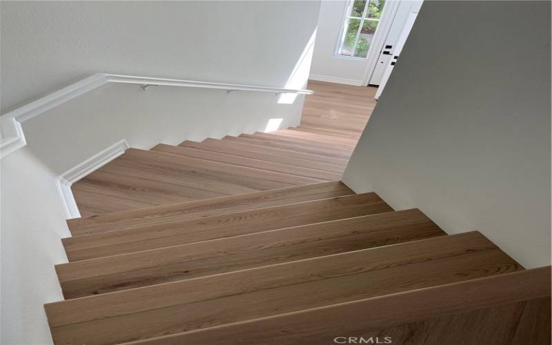 Stairs from front door and garage access.  New Luxury Vinyl plank flooring throughout the unit.