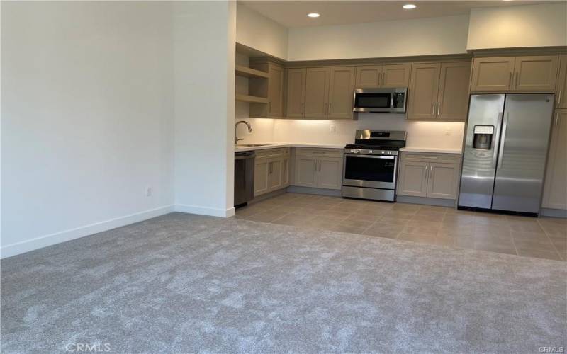Open concept, living, dining, kitchen. Fridge included.