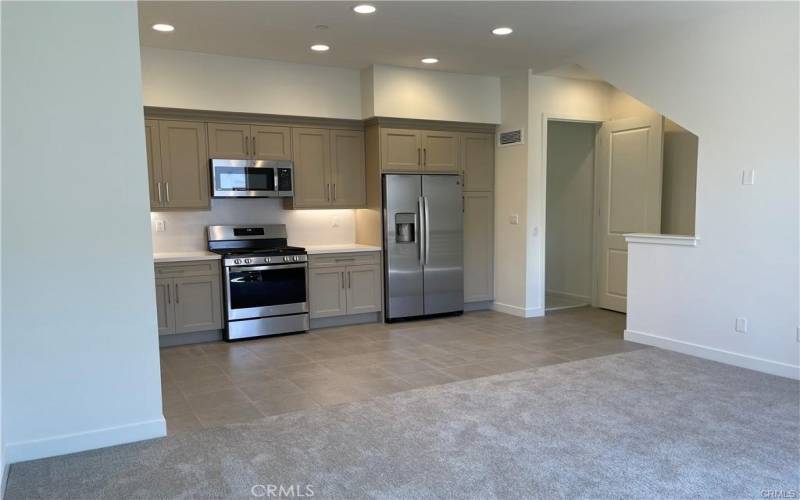 Open concept, living, dining, kitchen. Fridge included.