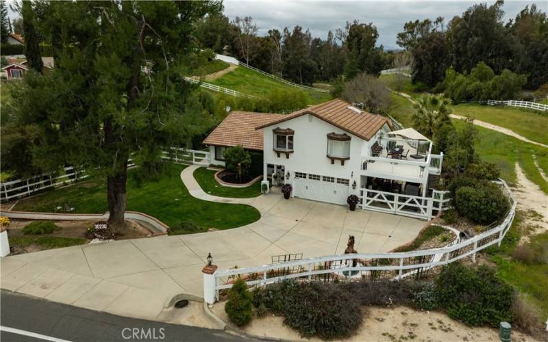 Large front yard and driveway with views surrounding the home.