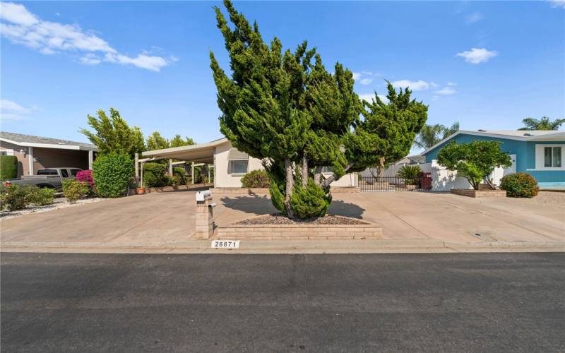 Circle driveway sweeps across two carports