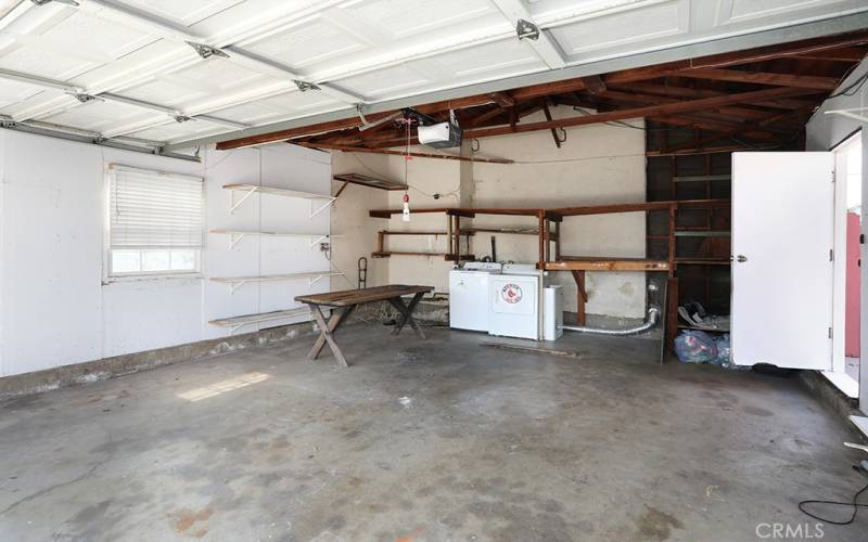 The garage has a window, door to backyard, lights and shelves!