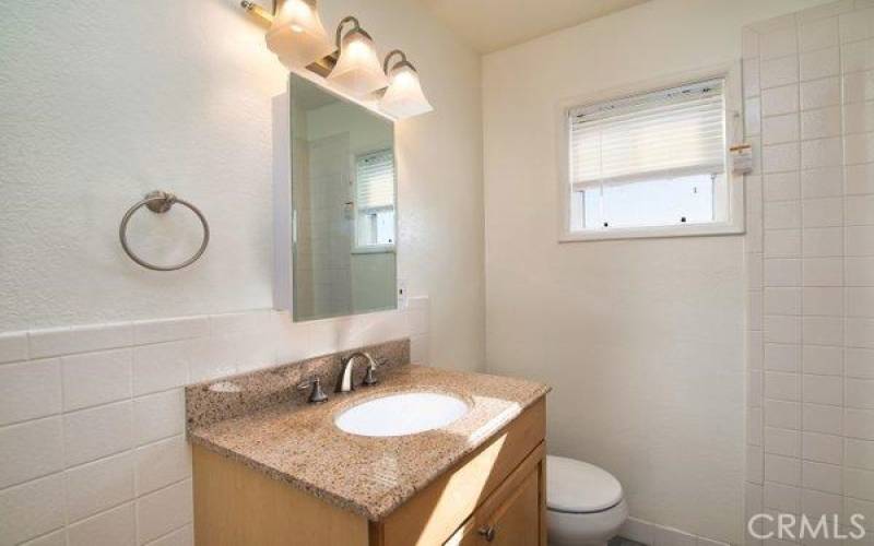 Remodeled En Suite Bathroom #1 with Granite Counter and Subway Tile Throughout