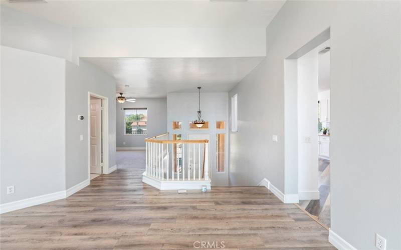 This modern and welcoming entryway leads into a light-filled, spacious area, seamlessly blending functionality and style