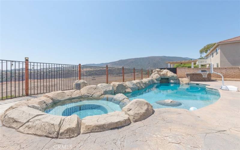 Relax and unwind in this spacious backyard oasis, featuring a stunning pool and breathtaking mountain views