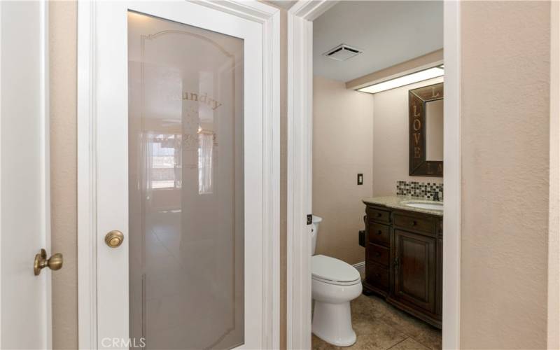 Half Bath Downstairs as you enter the Laundry Area.  Check ot the beautiful door.