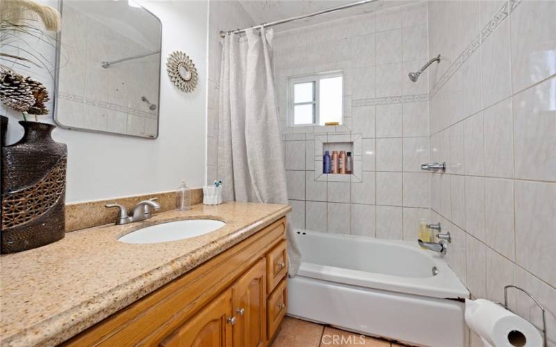 Hallway bathroom with shower/tub combo.