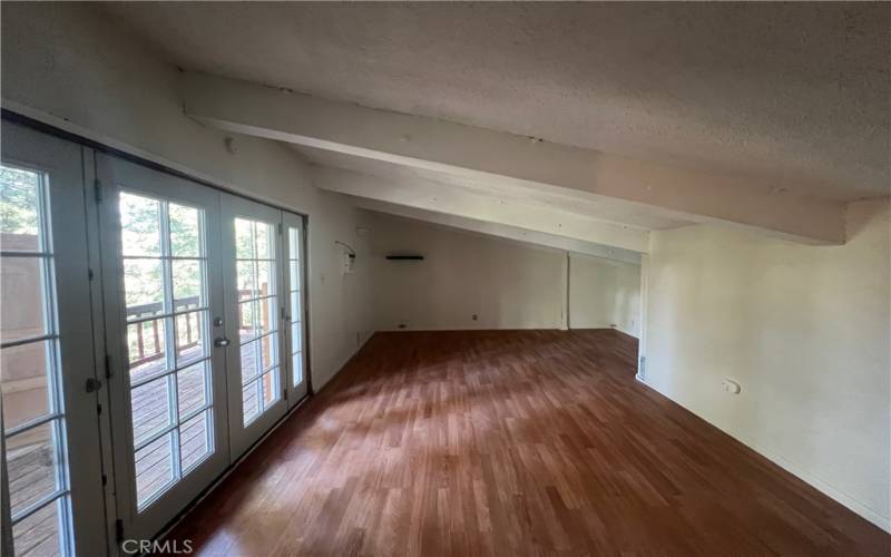 Top floor bedroom with French doors to private deck.