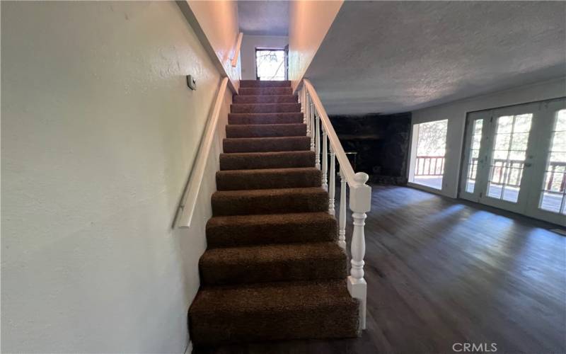 Stairs from entry to bottom floor.