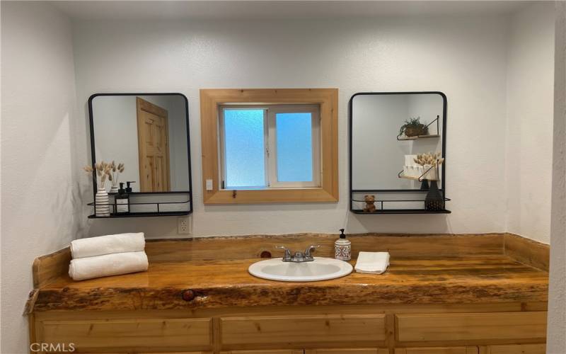 Remodel bathroom with beautiful custom wood counter and lots of storage......