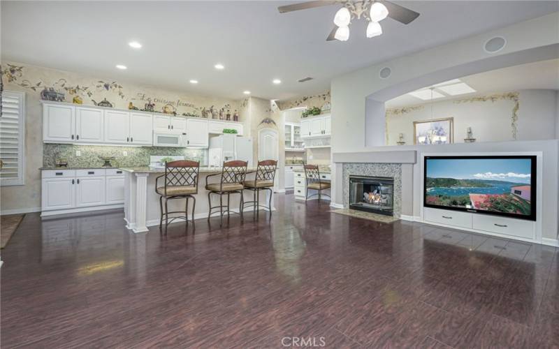 Family room with fireplace opens to kitchen