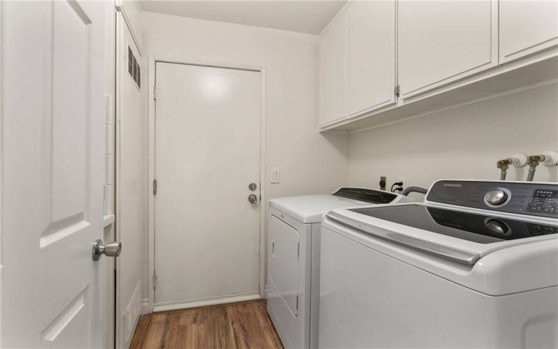 An indoor laundry room with convenient direct garage access.
