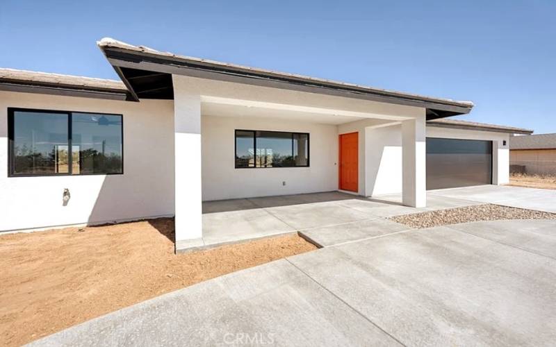 Front view of house. 2022 Modern construction with custom double driveway