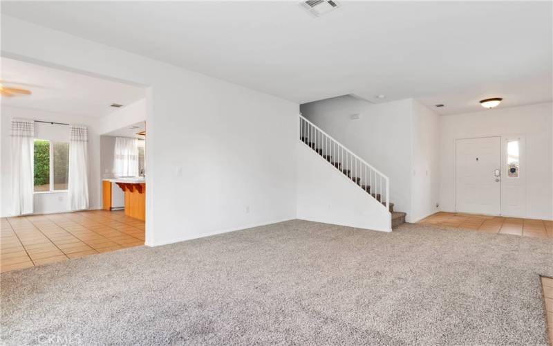 Living room with brand new carpet, fresh paint, and a cozy fireplace.