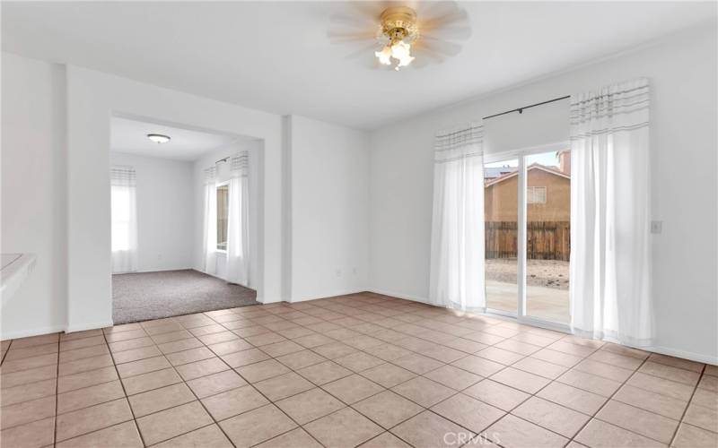 Large dining area with tile floor. Sliding door leads to rear patio.