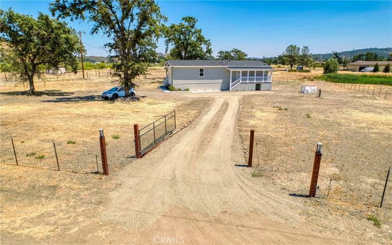 Gated & fenced yard, set well back from the road