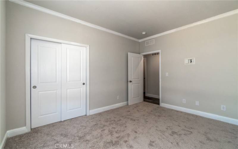 Second bedroom with plush carpet