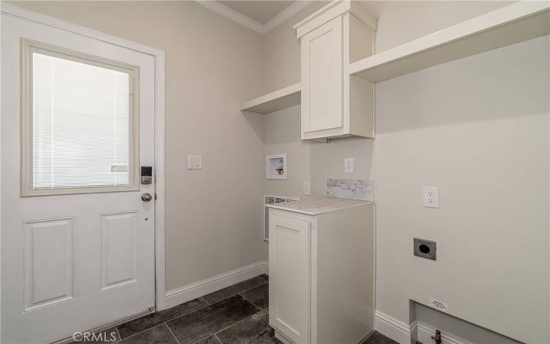 Utility room with storage and entrance to side porch