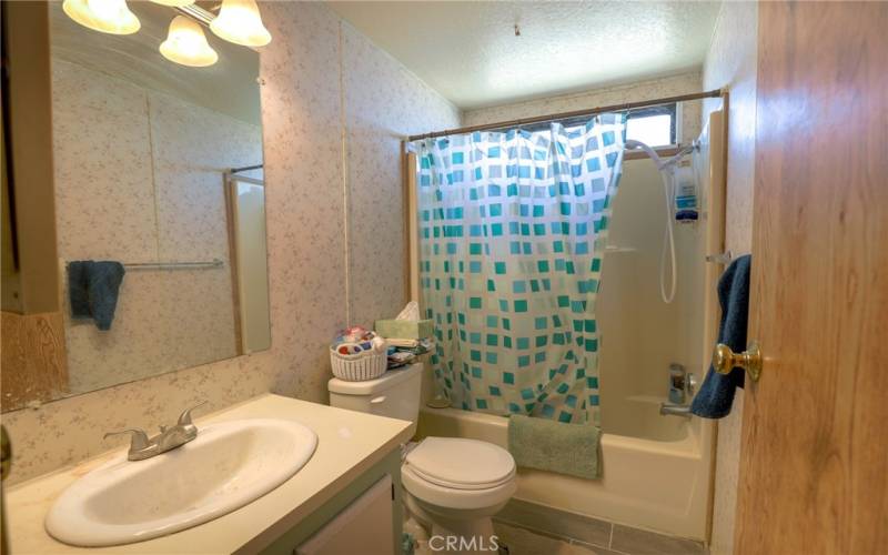The main bathroom features tile floors and a tub/shower combination.