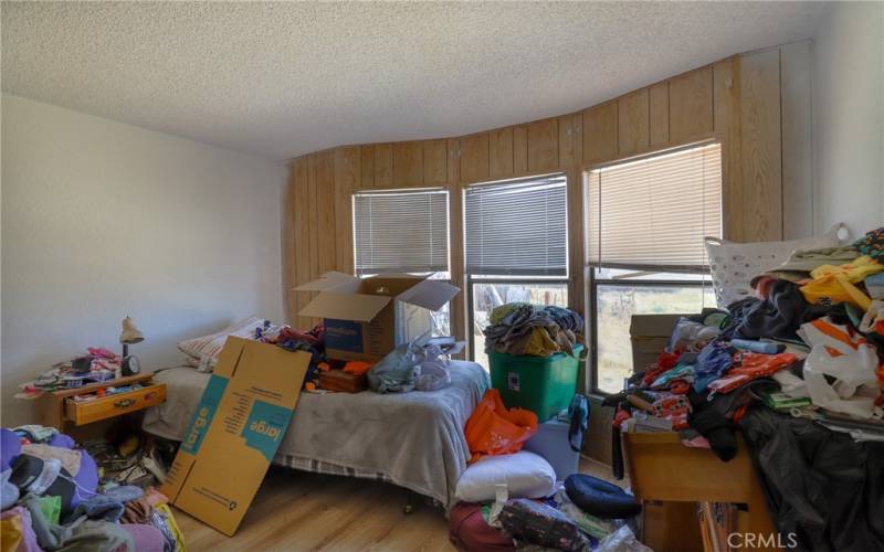 Bedroom 3 also has laminate wood floors and large windows.