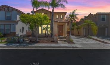 Inviting two-story home with a warm exterior, perfect for welcoming guests.