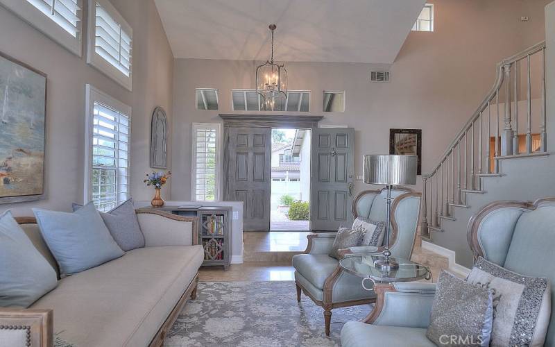 Step into an Exceptional Home through the double door through the Grand entryway with wooden staircase