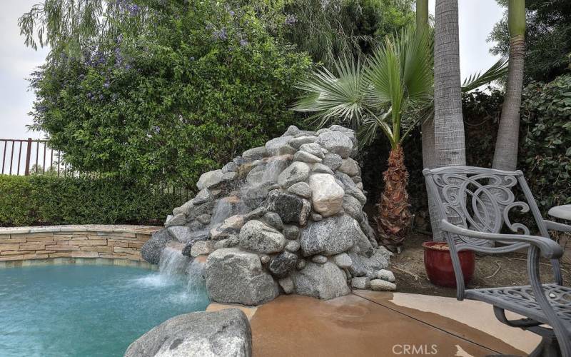 Wow, enjoy looking at this natural looking waterfall while taking a dip in the pool or spa