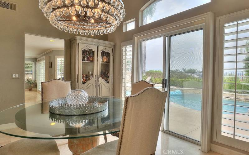 Living is easy from this impressive dining area with view of your resort style backyard and Saddleback Mountains