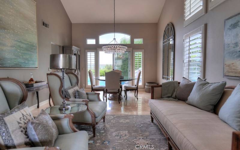 Cathedral ceilings, Travertine flooring, and high windows create a light and bright living room experience