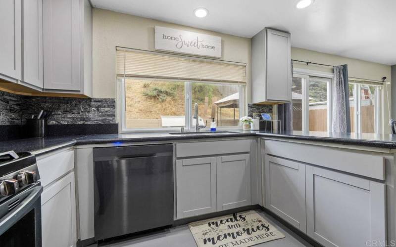 Dishwasher, Gas Stove, Stainless steel refrigerator. Beautiful window for natural light.