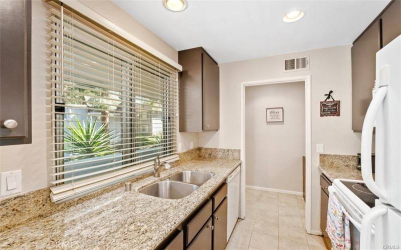 Spacious kitchen with granite countertops and deep stainless steel sink
