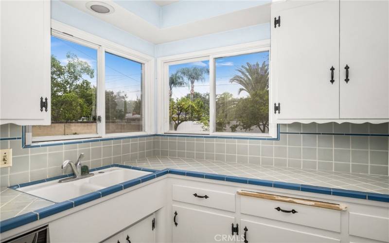 Kitchen with windows looking out to the backyard