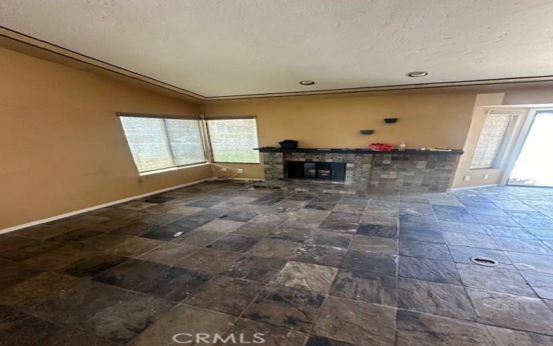 front room with fireplace beautiful tile floors