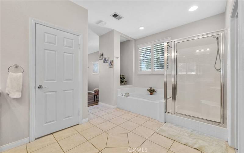 Primary Bathroom with soaking tub and glass enclosed shower.