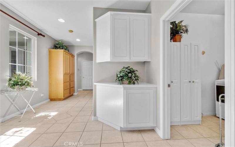 Spacious hallway with storage cabinets leading to additional 3 bedrooms.