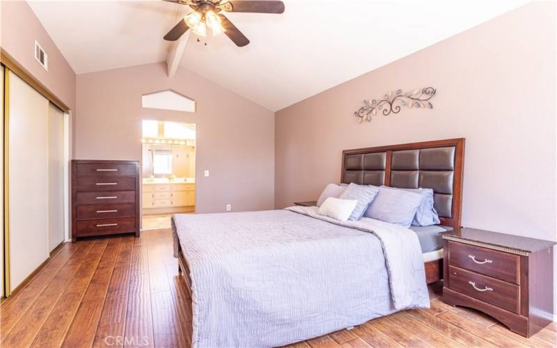 Upstairs primary bedroom with ceiling fan.