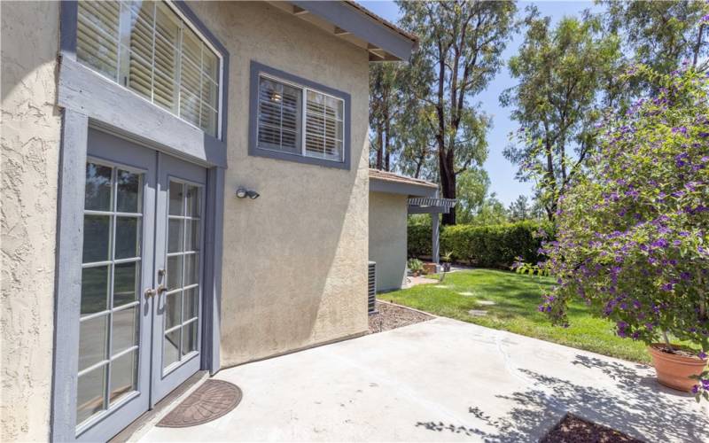 From French doors off of living room, patio and backyard.