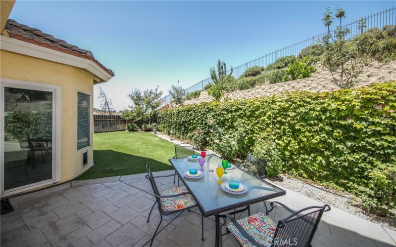 LOWER PATIO AREA ADJACENT TO KITCHEN AND FAMILY ROOM