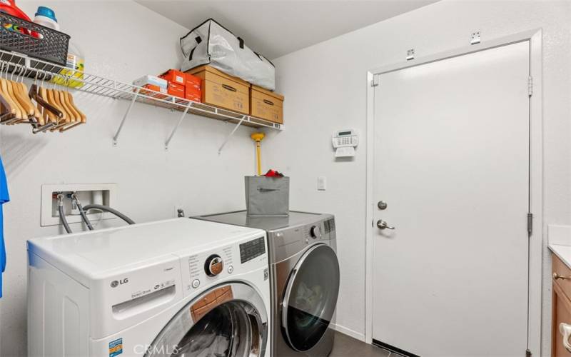 spacious laundry with sink and lots of cabinetry for storage