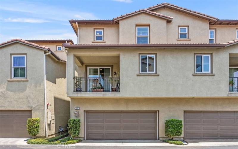 Double car attached garage w/balcony & living area  above